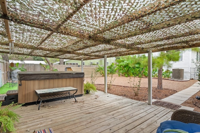 deck featuring a hot tub and cooling unit