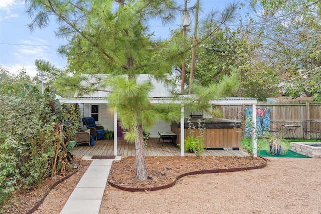 view of yard featuring a hot tub and a deck