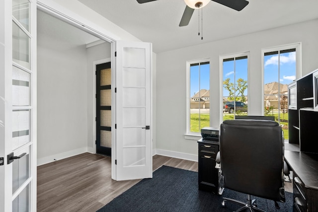 office space featuring ceiling fan, a wealth of natural light, french doors, and dark hardwood / wood-style flooring