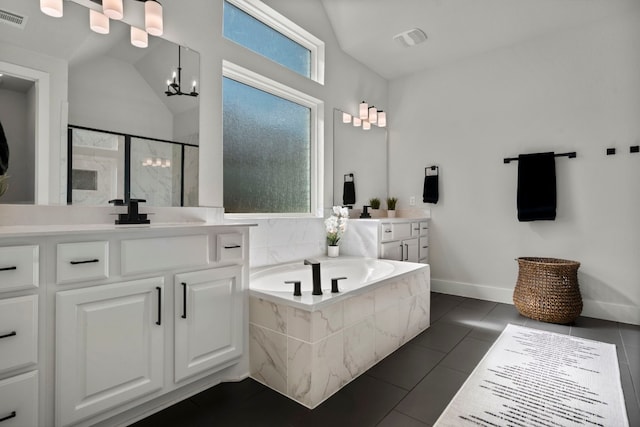 bathroom featuring independent shower and bath, vaulted ceiling, and tile patterned floors