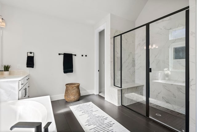 bathroom featuring tile patterned flooring, independent shower and bath, vanity, and vaulted ceiling