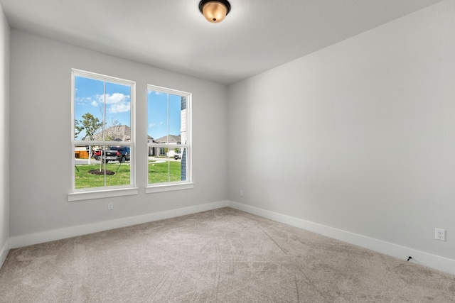 empty room featuring plenty of natural light and carpet