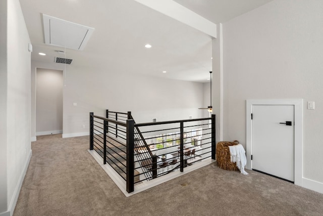 hall with light colored carpet