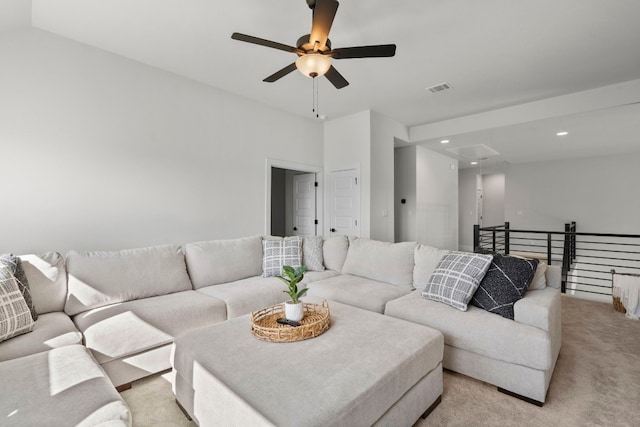 carpeted living room with ceiling fan