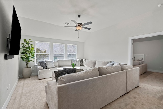 carpeted living room with ceiling fan and lofted ceiling