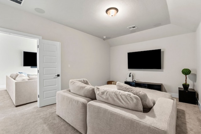 living room with light carpet and vaulted ceiling