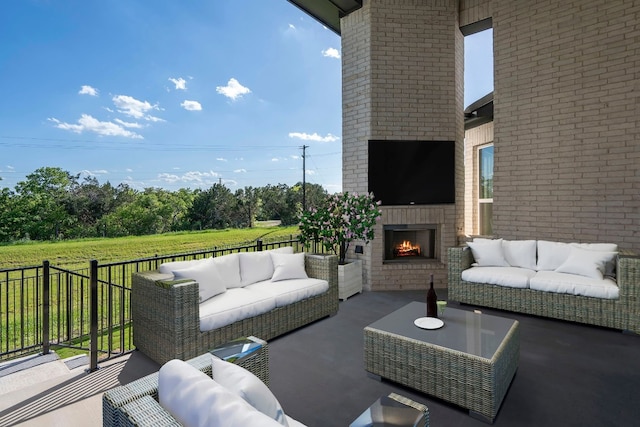 view of patio / terrace with an outdoor living space with a fireplace