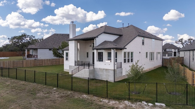 back of house featuring a lawn and a patio area