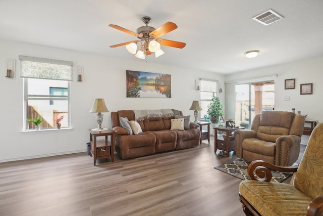 living room with ceiling fan, a healthy amount of sunlight, and light hardwood / wood-style flooring