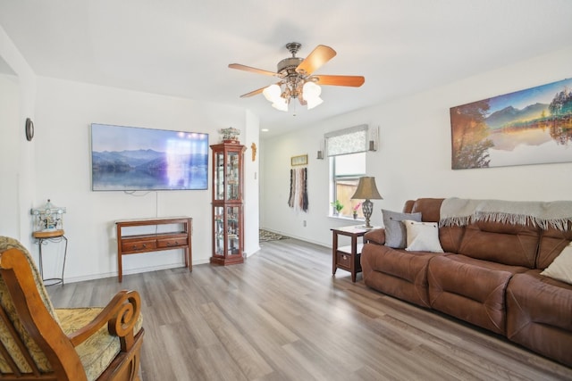 living room featuring ceiling fan and light hardwood / wood-style floors