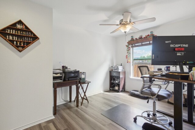 home office featuring wood-type flooring and ceiling fan