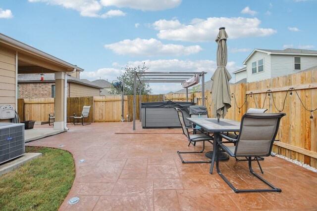 view of patio / terrace with a hot tub and central air condition unit