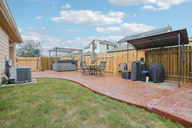 view of yard featuring a hot tub, a patio, and central air condition unit