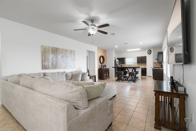 living room featuring ceiling fan and light tile patterned floors