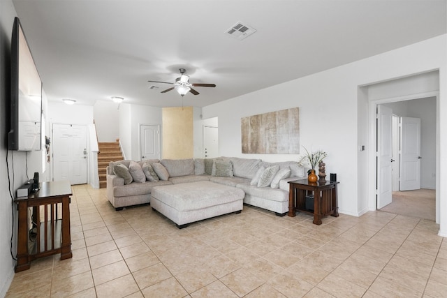 living room with ceiling fan and light tile patterned flooring