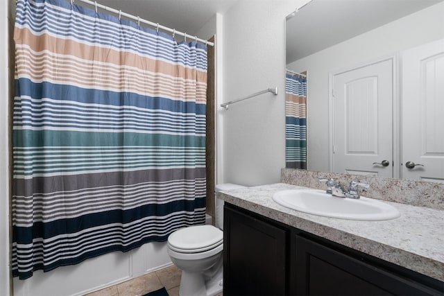 bathroom with tile patterned floors, toilet, vanity, and walk in shower