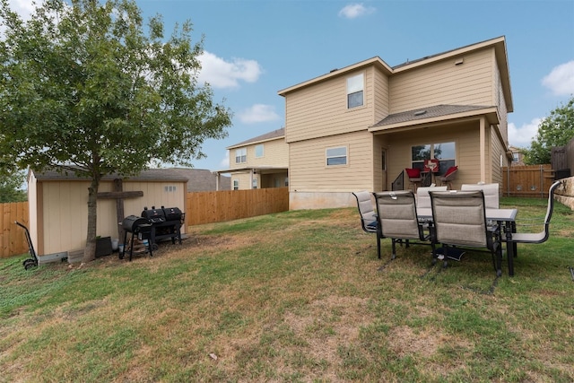 back of house featuring a yard and a shed