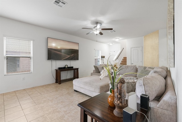 tiled living room with ceiling fan