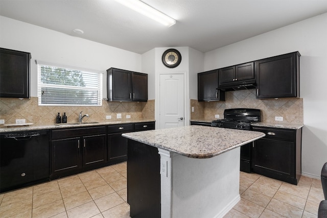 kitchen featuring black appliances, a kitchen island, sink, and tasteful backsplash