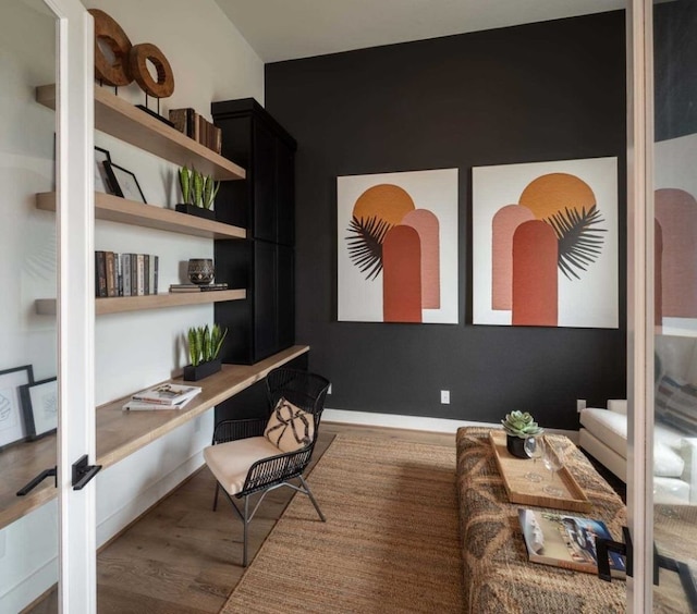 office area with wood-type flooring and built in desk