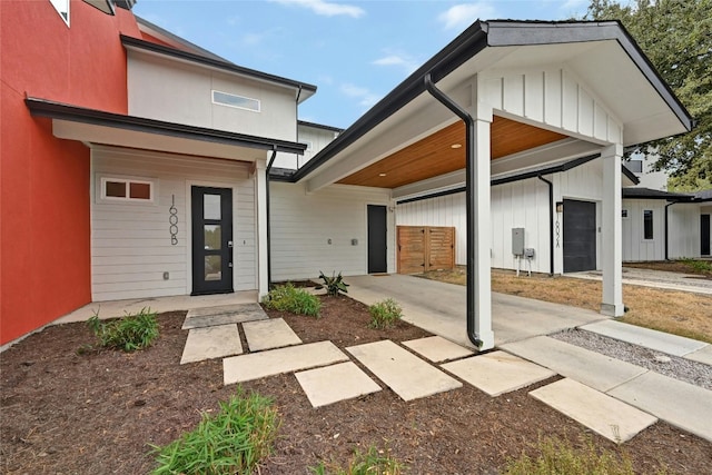 exterior space with a garage, board and batten siding, and stucco siding