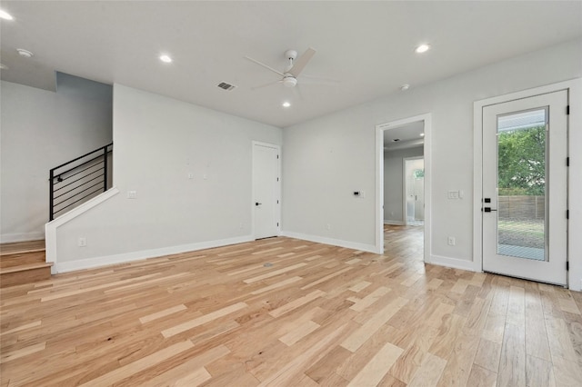 unfurnished room with light wood-type flooring and ceiling fan