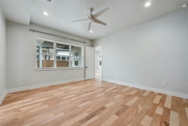 spare room with ceiling fan and light wood-type flooring