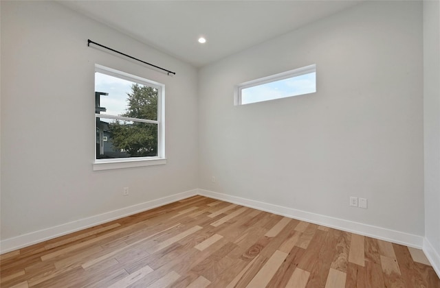 empty room with light hardwood / wood-style flooring