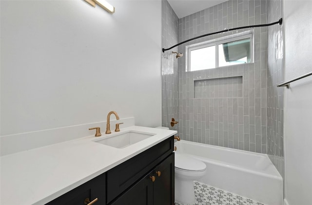 full bathroom featuring toilet, tiled shower / bath combo, and vanity