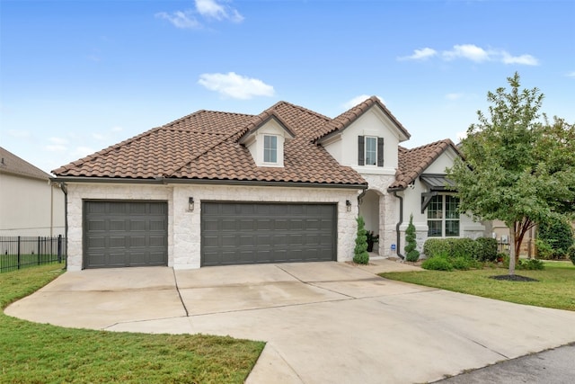 mediterranean / spanish house featuring a front yard