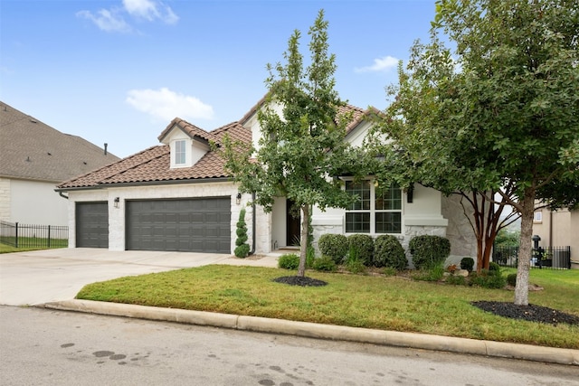 view of front of house featuring a garage and a front yard