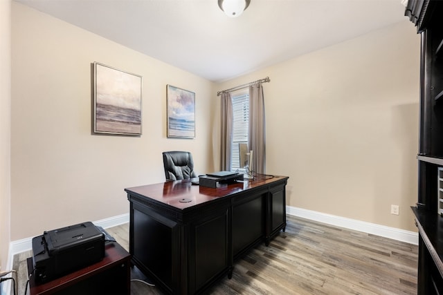 home office with hardwood / wood-style flooring