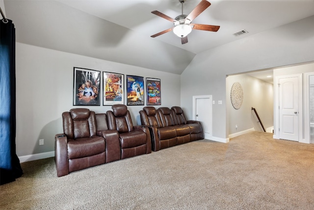 carpeted home theater featuring ceiling fan and vaulted ceiling