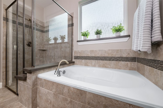 bathroom featuring separate shower and tub