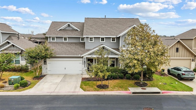 craftsman inspired home featuring a garage and a front lawn