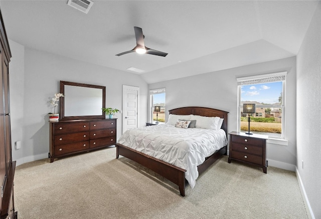 bedroom with lofted ceiling, light carpet, and ceiling fan