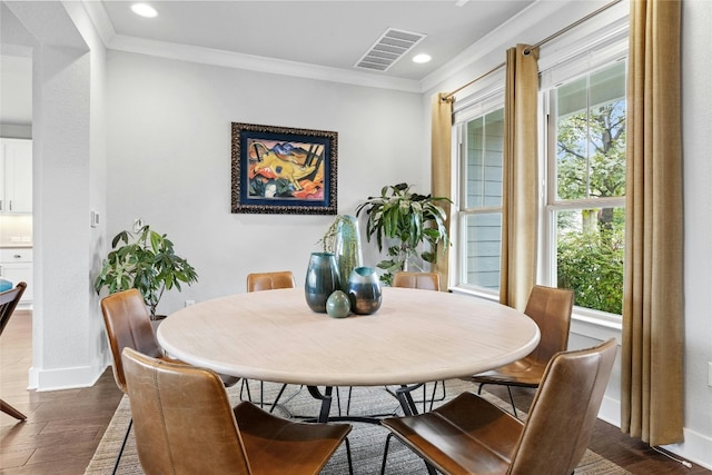 dining area with dark hardwood / wood-style floors and ornamental molding