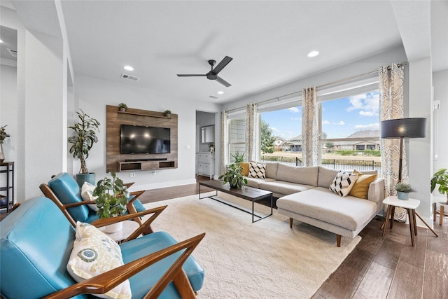 living room featuring wood-type flooring and ceiling fan