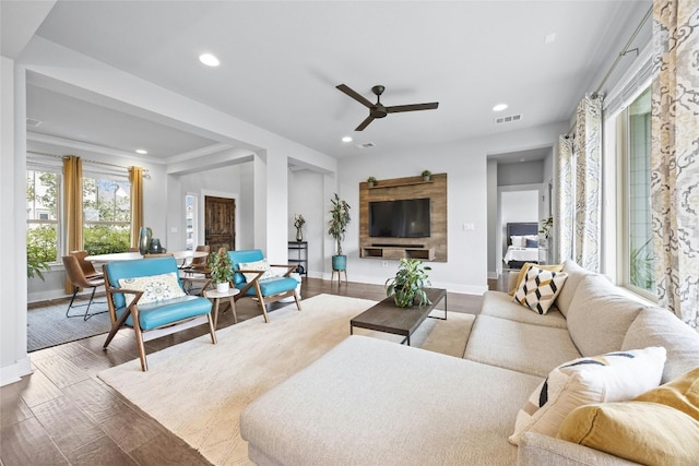 living room featuring wood-type flooring and ceiling fan