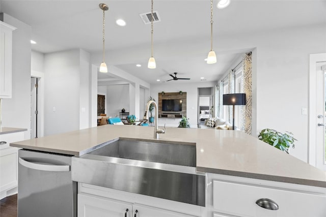 kitchen with white cabinetry, sink, ceiling fan, dark hardwood / wood-style floors, and stainless steel dishwasher