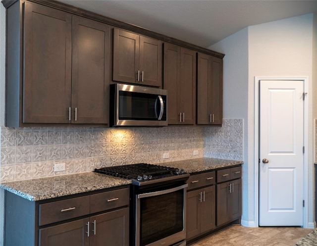 kitchen featuring dark brown cabinets, appliances with stainless steel finishes, tasteful backsplash, and stone countertops