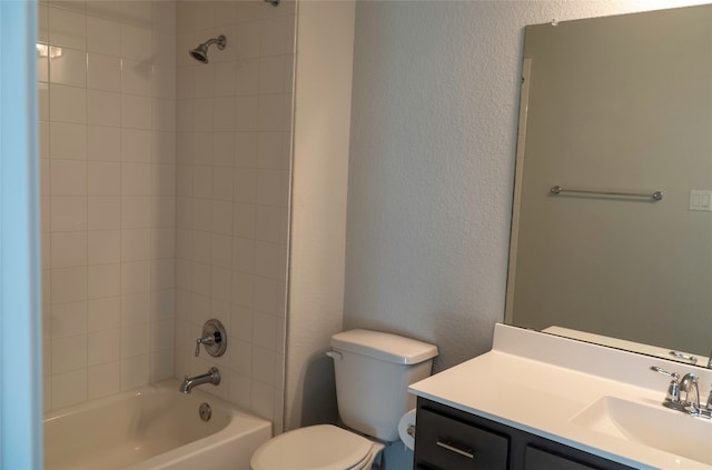 full bathroom featuring toilet, tiled shower / bath combo, and vanity