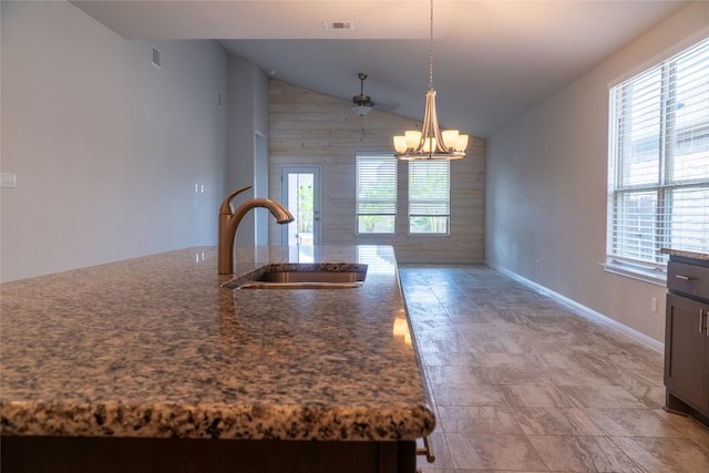 kitchen with a healthy amount of sunlight, sink, pendant lighting, and lofted ceiling