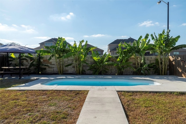 view of pool featuring a patio area, a yard, and a gazebo