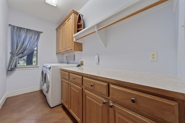 laundry area featuring cabinets, washer and dryer, and light tile patterned floors