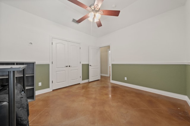 unfurnished bedroom with tile patterned flooring, lofted ceiling, ceiling fan, and a closet