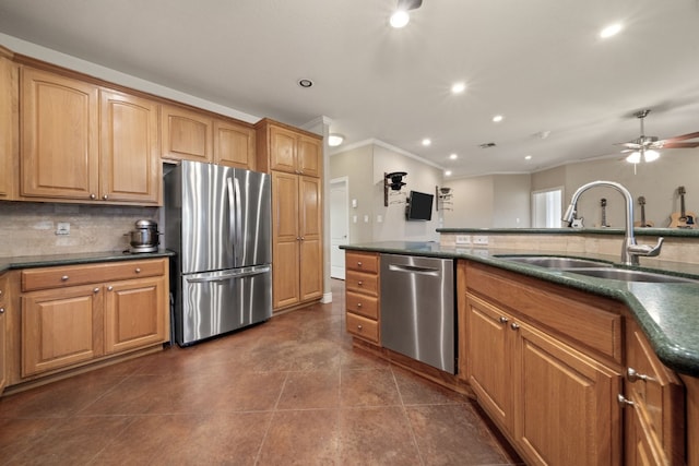 kitchen featuring ornamental molding, stainless steel appliances, dark tile patterned floors, sink, and decorative backsplash