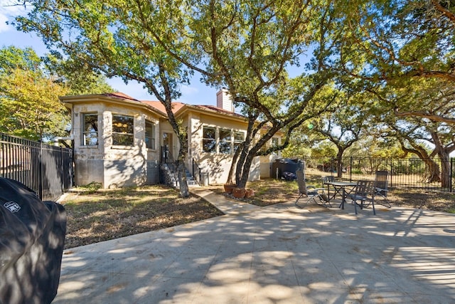 bungalow featuring a patio