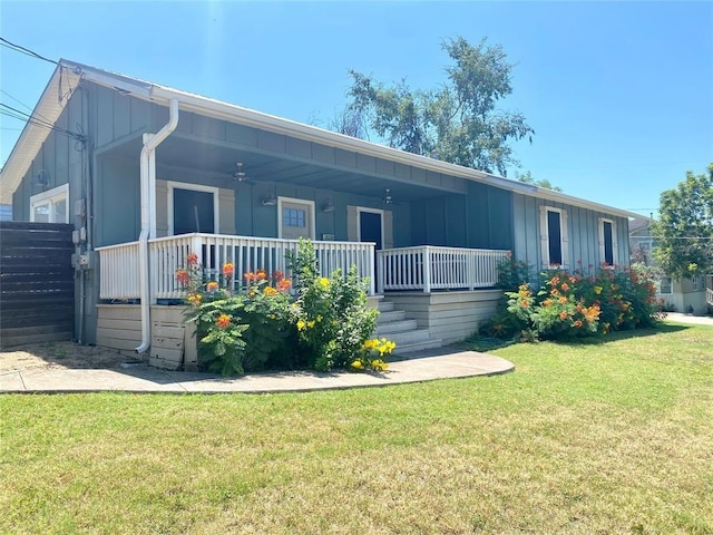 view of front of house with a front yard and a porch