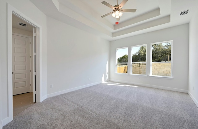 7701 Becasseau Dr, Austin, TX 78738 - unfurnished room with carpet flooring, a ceiling fan, and a raised ceiling